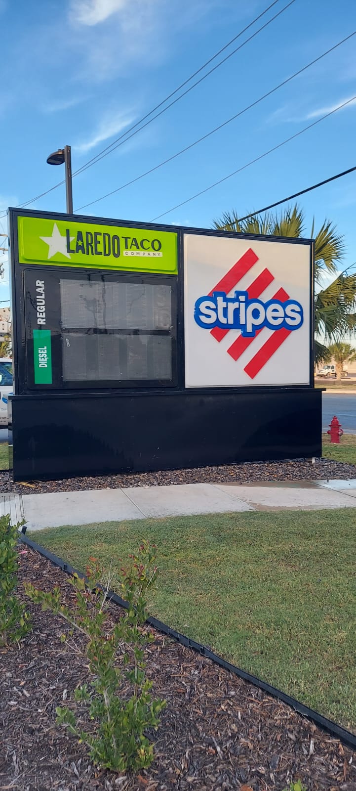 Elevated Stripes store presence with a renovated monument sign, integrating Laredo Taco Company branding.